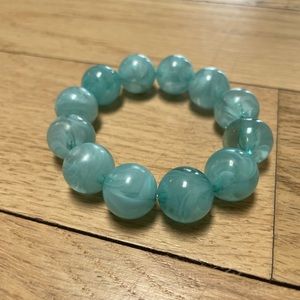 Blue spheres elastic bracelet.